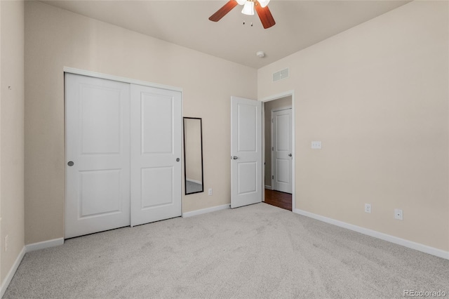 unfurnished bedroom with carpet floors, a ceiling fan, visible vents, baseboards, and a closet