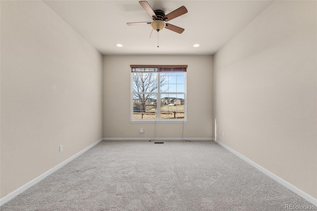 carpeted spare room featuring a ceiling fan, recessed lighting, and baseboards