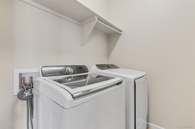 clothes washing area with washing machine and dryer and laundry area