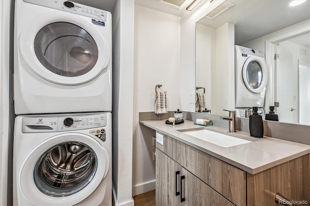 laundry room with stacked washer / dryer and sink