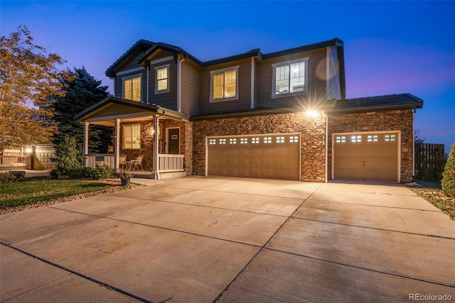 view of front of house featuring a porch and a garage