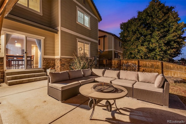 patio terrace at dusk featuring an outdoor hangout area