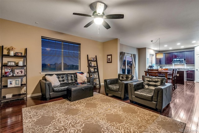 living room with ceiling fan and dark hardwood / wood-style floors