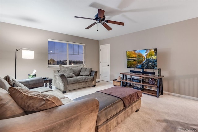 carpeted living room with ceiling fan