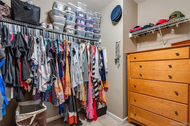 walk in closet with carpet flooring