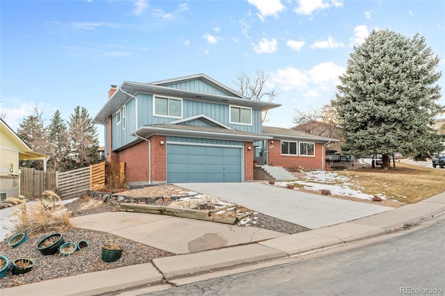 view of front of property featuring a garage, concrete driveway, a chimney, fence, and brick siding