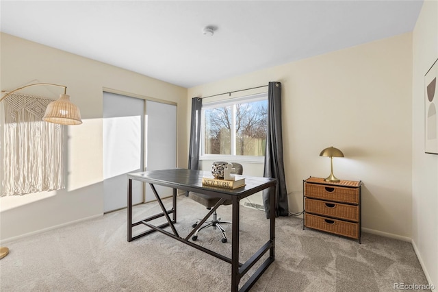 carpeted office space featuring baseboards