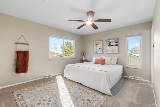 bedroom featuring multiple windows, visible vents, and baseboards