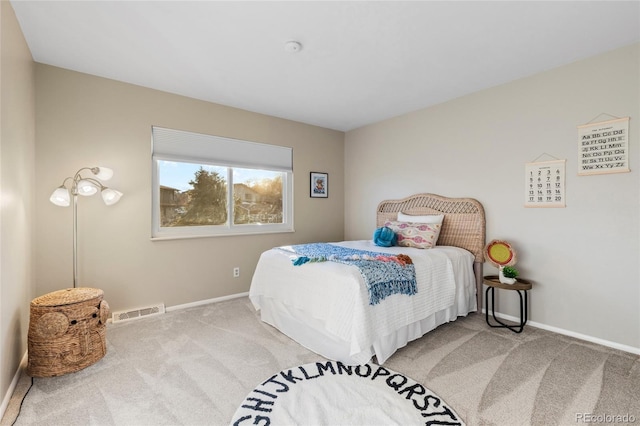 carpeted bedroom featuring visible vents and baseboards