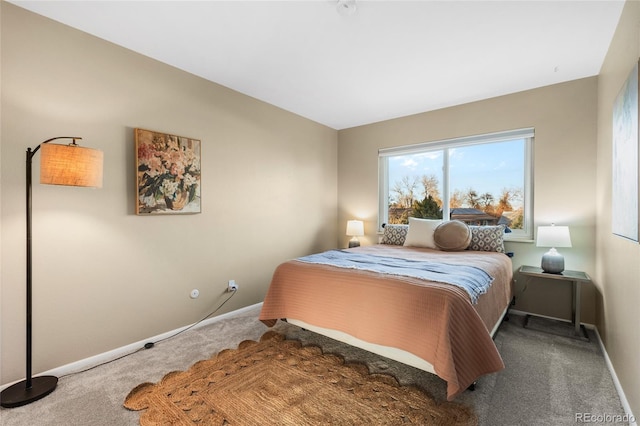 carpeted bedroom featuring baseboards