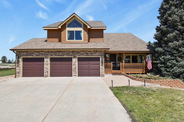 view of front of property with a porch, roof with shingles, stone siding, concrete driveway, and a garage
