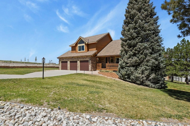 view of front facade featuring a porch, concrete driveway, and a front lawn