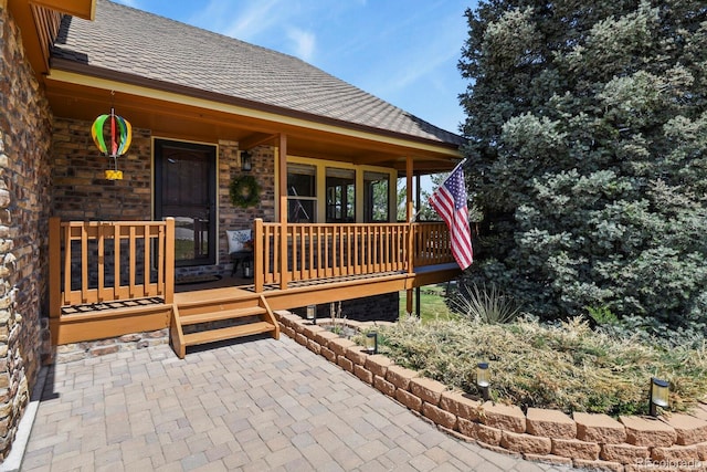 entrance to property with roof with shingles
