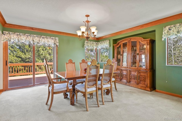dining room with ornamental molding, light carpet, a notable chandelier, and a healthy amount of sunlight