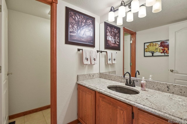 bathroom featuring baseboards, tile patterned flooring, and vanity