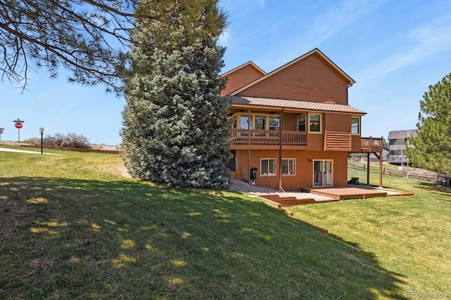 back of property with a yard, a patio area, and a balcony