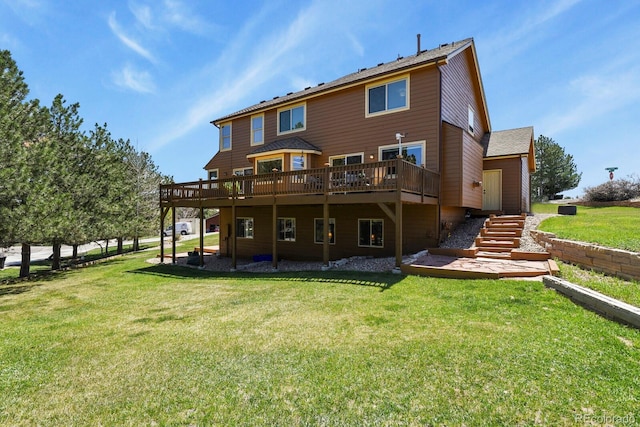 back of house featuring a yard, a wooden deck, and stairs