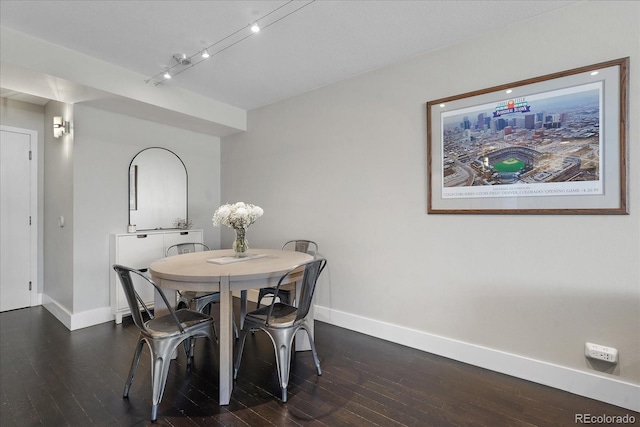 dining room with dark hardwood / wood-style flooring