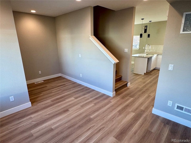 empty room featuring light hardwood / wood-style floors and sink