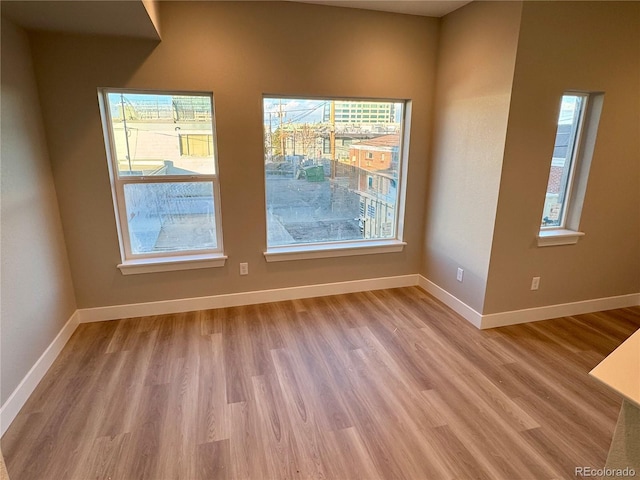 unfurnished room with light hardwood / wood-style flooring