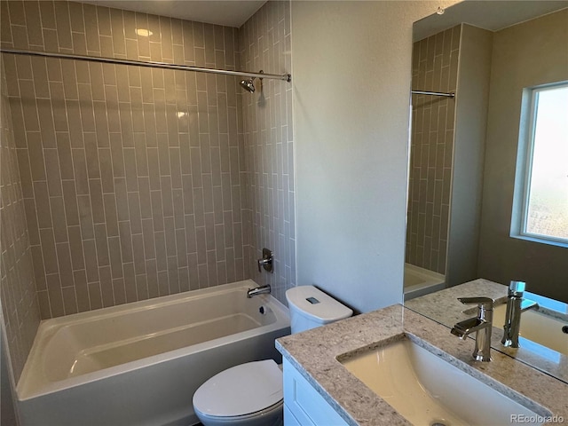 full bathroom featuring vanity, tiled shower / bath combo, and toilet