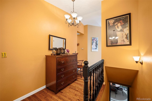 bedroom with an inviting chandelier and light hardwood / wood-style floors