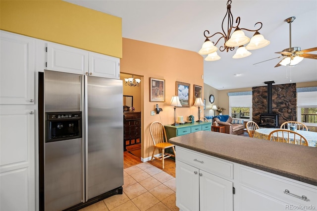 kitchen featuring white cabinetry, decorative light fixtures, and stainless steel refrigerator with ice dispenser