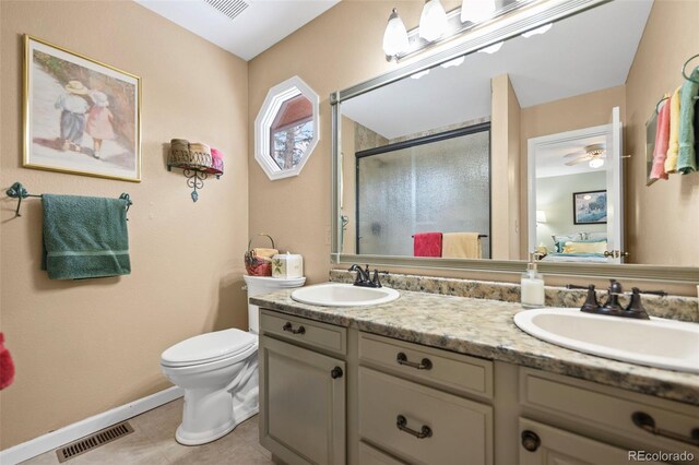 bathroom with vanity, toilet, tile patterned floors, and a shower with shower door