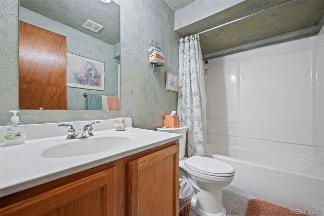 full bathroom featuring vanity, shower / bath combination with curtain, and toilet