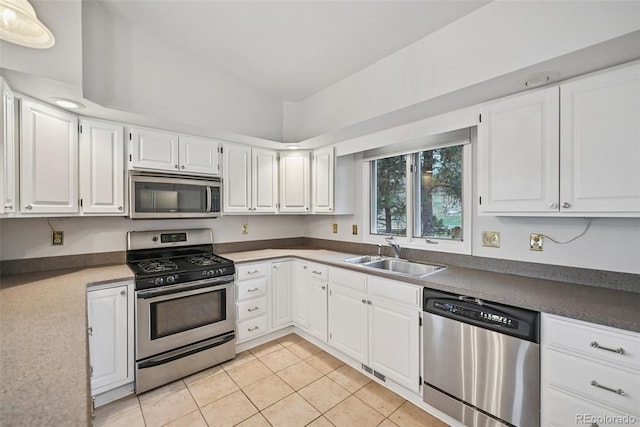 723 Eaton Rd, Palmer Lake, CO 80133 - kitchen featuring vaulted ceiling, a sink, light tile patterned flooring, appliances with stainless steel finishes, and white cabinetry