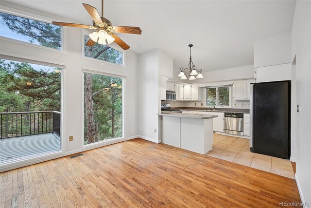 723 Eaton Rd, Palmer Lake, CO 80133 - kitchen featuring white cabinets, stainless steel appliances, visible vents, light wood-style floors, and a peninsula