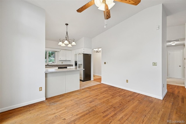 723 Eaton Rd, Palmer Lake, CO 80133 - kitchen with white cabinets, stainless steel fridge with ice dispenser, light countertops, a sink, and ceiling fan with notable chandelier