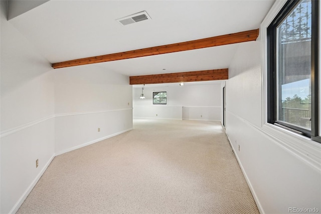 723 Eaton Rd, Palmer Lake, CO 80133 - spare room featuring beamed ceiling, visible vents, baseboards, and light carpet