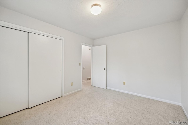 723 Eaton Rd, Palmer Lake, CO 80133 - unfurnished bedroom with visible vents, baseboards, carpet flooring, and a closet