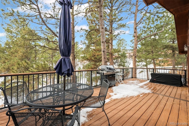 723 Eaton Rd, Palmer Lake, CO 80133 - wooden deck with outdoor dining area and a grill