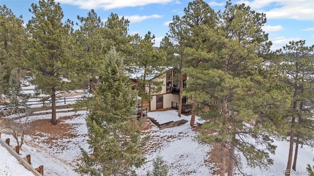 723 Eaton Rd, Palmer Lake, CO 80133 - snowy yard with fence and a balcony