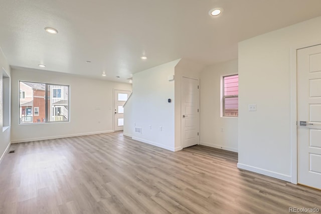 unfurnished living room featuring light hardwood / wood-style floors