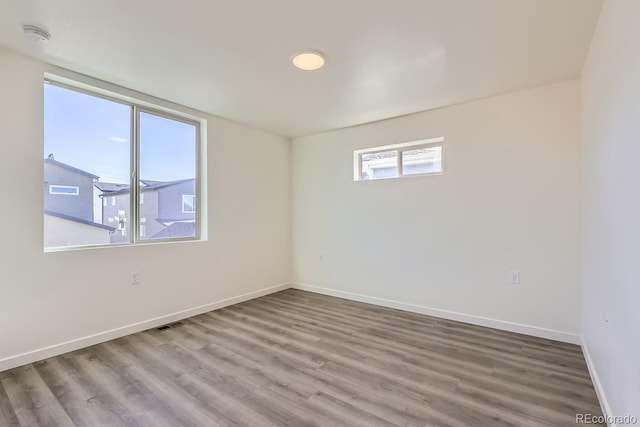 spare room with hardwood / wood-style floors