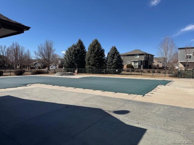 pool featuring a patio area and fence