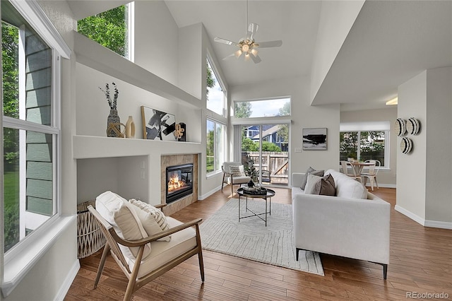 1229 James Cir Unit 1, Lafayette, CO 80026 - living area with a tile fireplace, plenty of natural light, high vaulted ceiling, ceiling fan, and wood finished floors