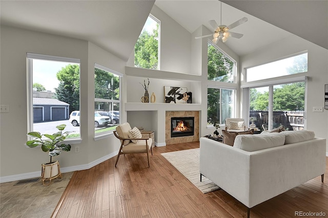 1229 James Cir Unit 1, Lafayette, CO 80026 - living room featuring a tile fireplace, high vaulted ceiling, hardwood / wood-style flooring, and ceiling fan