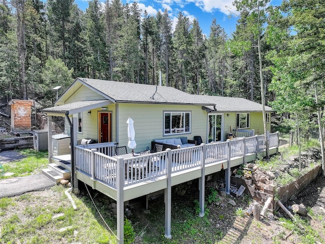 8340 London Ln, Conifer, CO 80433 - rear view of property with an outdoor living space, a deck, a forest view, and roof with shingles