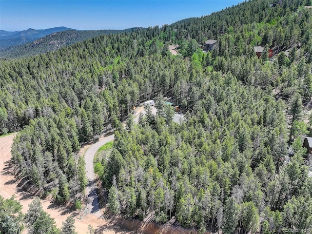 8340 London Ln, Conifer, CO 80433 - aerial view of a heavily wooded area and a mountainous background