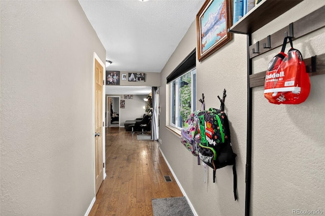 8340 London Ln, Conifer, CO 80433 - corridor featuring wood finished floors, a textured wall, and a textured ceiling