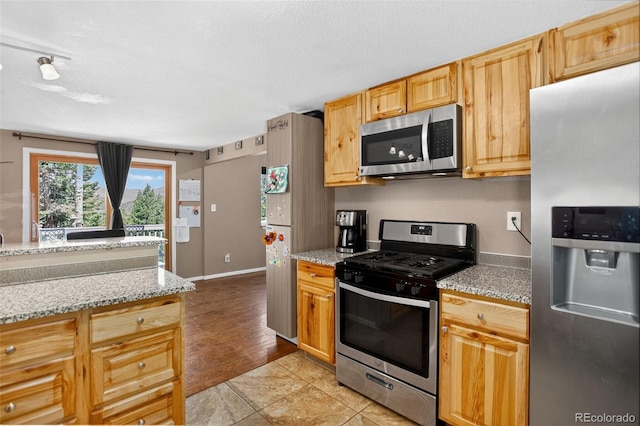 8340 London Ln, Conifer, CO 80433 - kitchen featuring appliances with stainless steel finishes and light stone counters