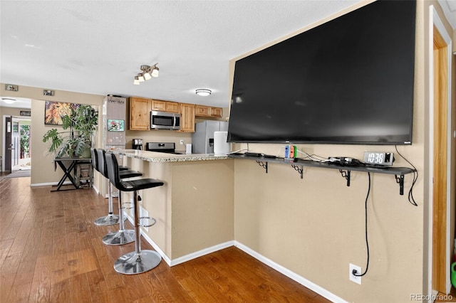 8340 London Ln, Conifer, CO 80433 - kitchen with stainless steel microwave, refrigerator with ice dispenser, stove, and dark wood-style flooring