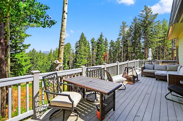 8340 London Ln, Conifer, CO 80433 - wooden deck with an outdoor hangout area and outdoor dining space