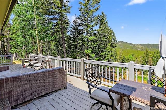 8340 London Ln, Conifer, CO 80433 - wooden deck with outdoor dining space and a mountain view