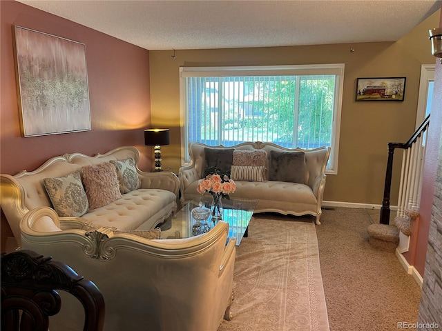 living room featuring a textured ceiling and carpet floors