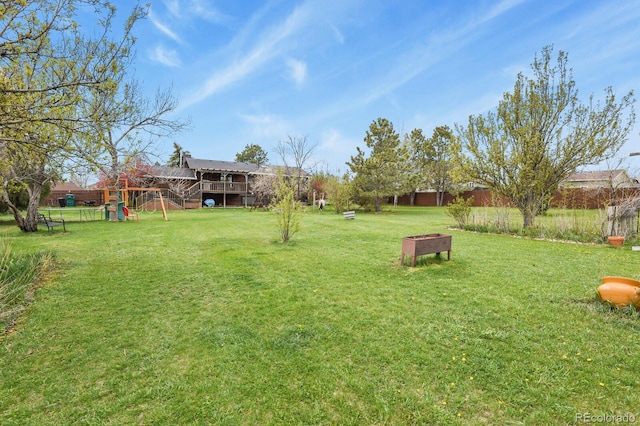 view of yard with a playground and fence